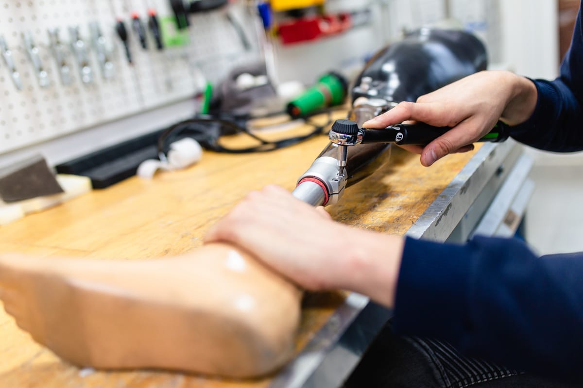 Disabled man working in amputee shop for production prosthetic e